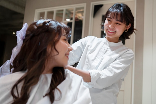 Foto mujer arreglándose el pelo en una peluquería japonesa