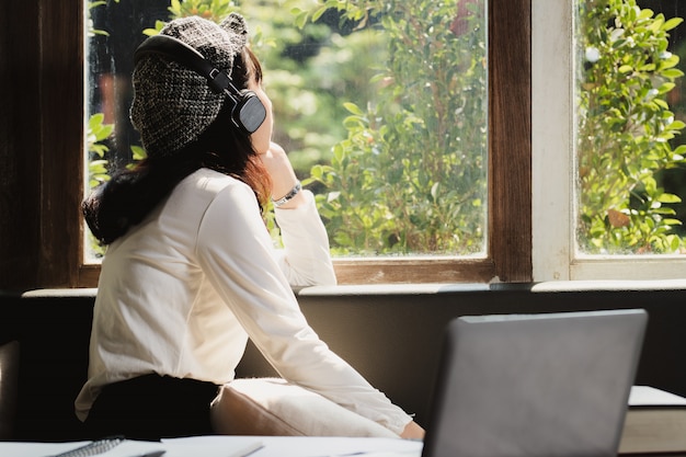 Mujer de Asia escuchando música con solitaria.