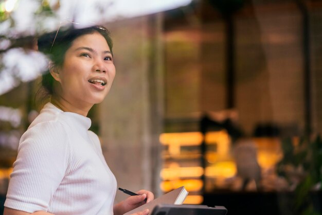 Mujer asiática freelance digital nómada carrera felicidad trabajo alegre sonriente trabajando en línea con dispositivo inteligente tableta teléfono inteligente ocupación en el extranjero proyecto trabajo en cualquier lugar nuevo estilo de vida sin marco