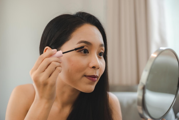 Mujer asiática joven con la piel de la cara de belleza, maquillaje de spa bonito y cosmético femenino