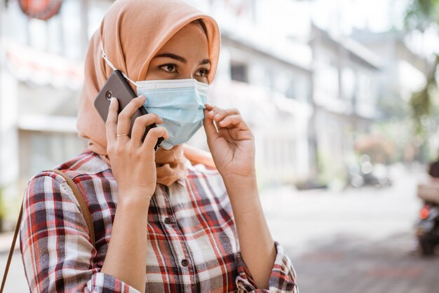 Mujer asiática con mascarilla para evitar virus contagiosos