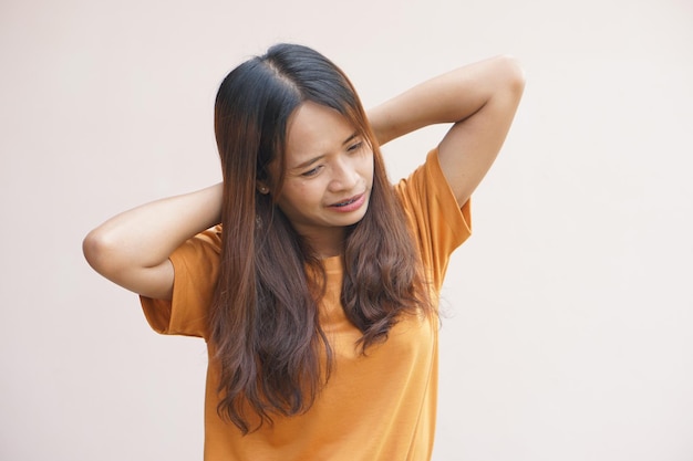 Mujer asiática que sufre de dolor de cuello por el trabajo