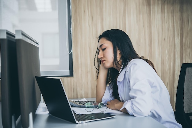 Mujer asiática que trabaja en la oficina Mujer de negocios joven estresada por la sobrecarga de trabajo con mucho archivo en el escritorio Gente de Tailandia