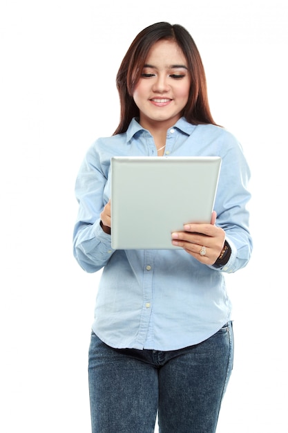 Mujer asiática sonriente que usa la tableta