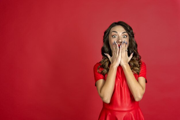 Mujer asustada sobre un fondo rojo.