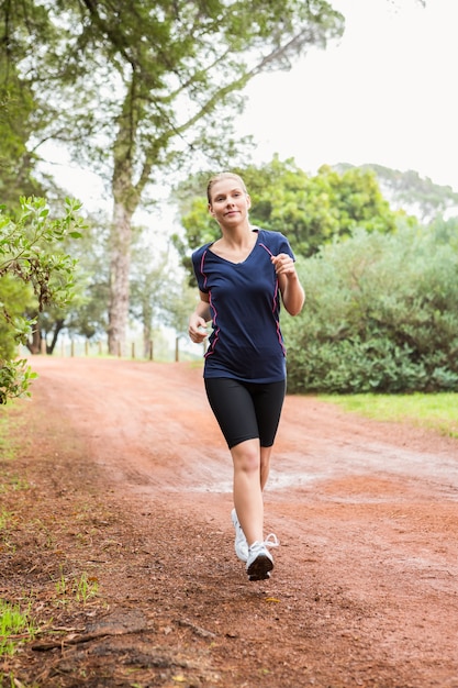 Mujer atlética corriendo en un sendero