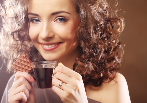 Mujer atractiva con café y galletas