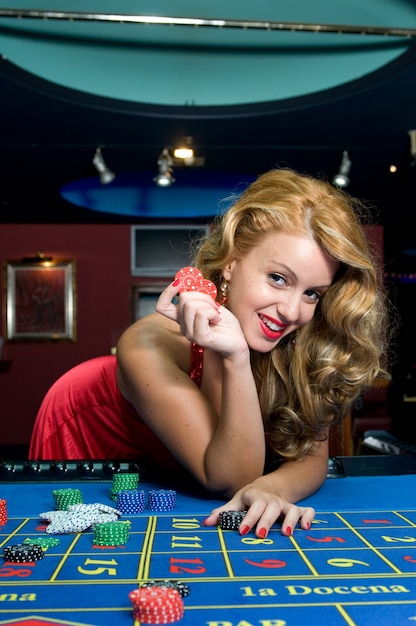 Mujer atractiva divirtiéndose en un casino mientras gana