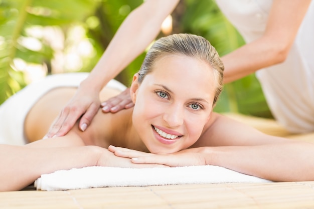 Mujer atractiva recibiendo masajes en la espalda
