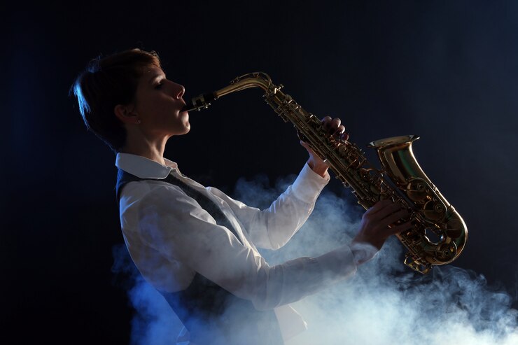 Foto mujer atractiva toca el saxofón en el humo