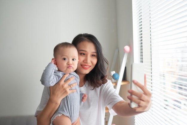 Mujer con un bebé haciendo un selfie