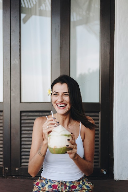 Mujer bebiendo un coco fresco