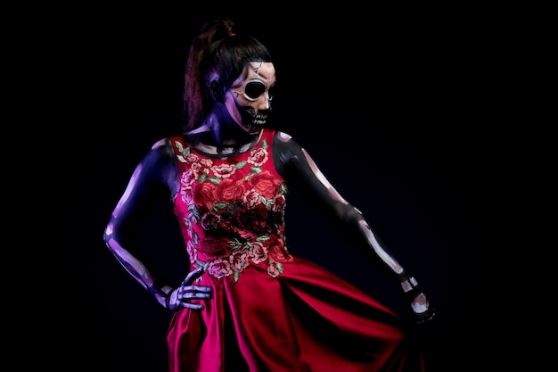 Mujer con Body paint de calavera con vestido Rojo y fondo azul por dia de muertos