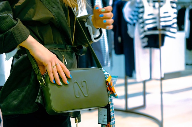 una mujer con una bolsa en la tienda y sosteniendo la bolsa en sus manos