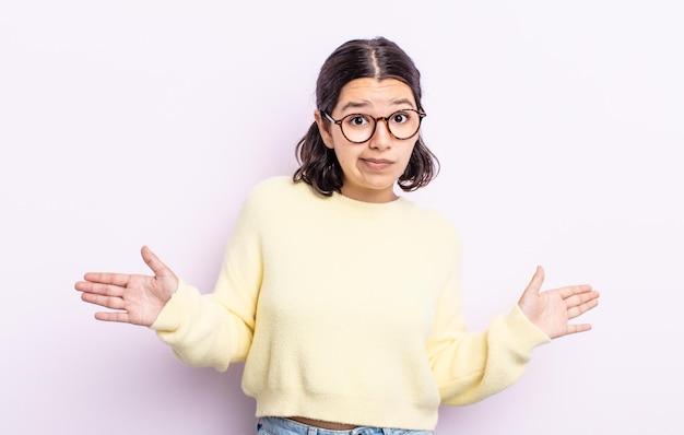 Mujer bonita adolescente que se siente perpleja y confundida, insegura de la respuesta o decisión correcta, tratando de tomar una decisión