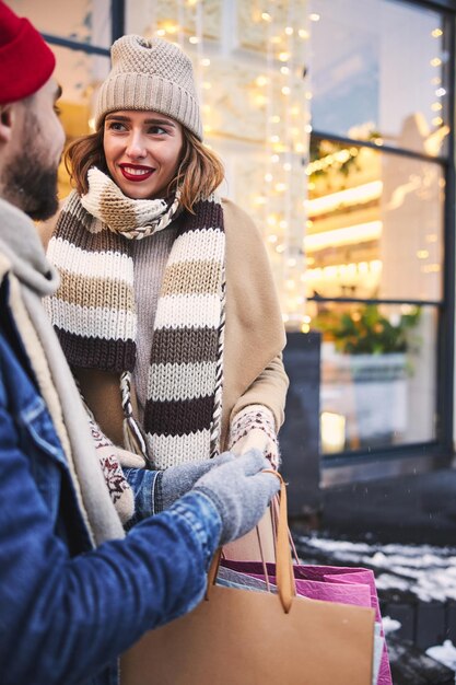 Mujer bonita alegre yendo de compras con su novio