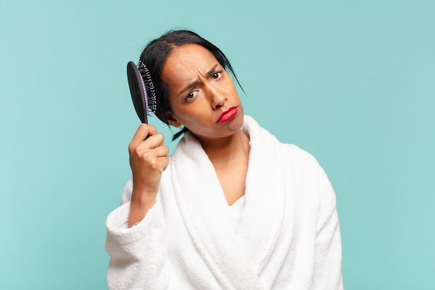 Una mujer bonita americana. concepto de cepillo de pelo concepto de cepillo de pelo