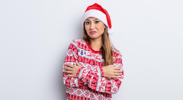 Mujer bonita asiática encogiéndose de hombros, sintiéndose confusa e insegura. concepto de navidad