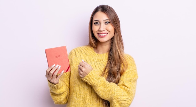 mujer bonita asiática que se siente feliz y enfrenta un desafío o celebra. concepto de agenda