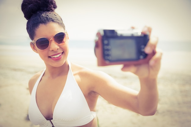 Mujer bonita en bikini tomando selfie