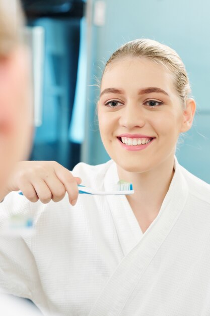 Mujer bonita cepillarse los dientes