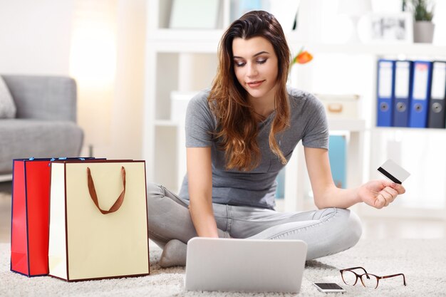 Foto mujer bonita de compras en línea con tarjeta de crédito