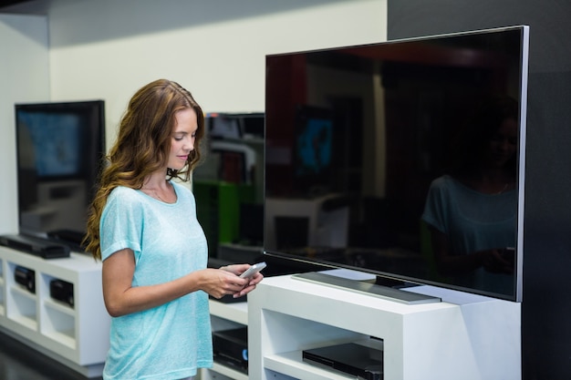 Mujer bonita de compras para la nueva televisión