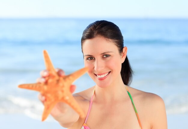 Mujer bonita con una estrella de mar