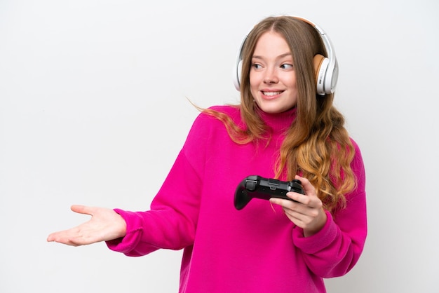 Mujer bonita joven jugando con un controlador de videojuegos aislado en fondo blanco con expresión de sorpresa mientras mira de lado