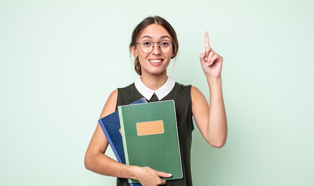 Mujer bonita joven que se siente como un genio feliz y emocionado después de realizar una idea. concepto universitario