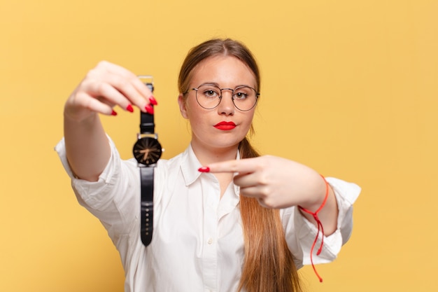 Mujer bonita joven. señalando el concepto de puntualidad gesto