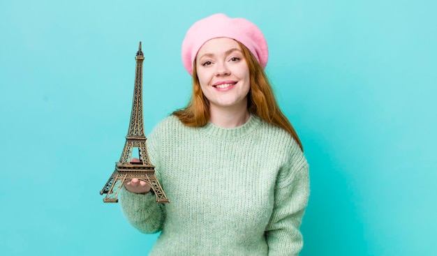 Mujer bonita pelirroja que parece feliz y gratamente sorprendida concepto de francia