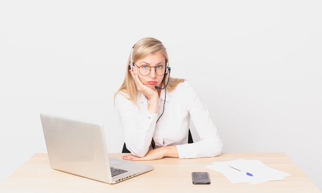 Mujer bonita rubia joven mujer rubia que se siente aburrida, frustrada y con sueño después de un cansado y trabajando con una computadora portátil