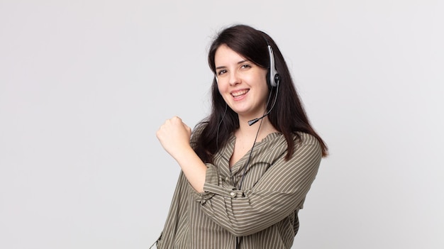 Mujer bonita sintiéndose feliz y enfrentando un desafío o celebrando. agente asistente con un auricular