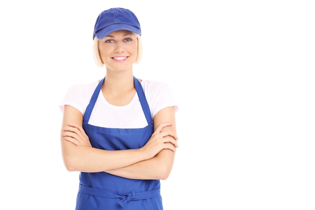 Una mujer bonita con un uniforme azul sobre fondo blanco.