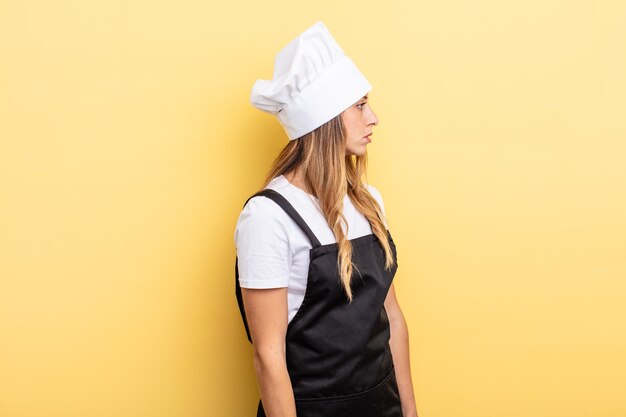 Mujer bonita en vista de perfil pensando, imaginando o soñando despierta. concepto de cocinero