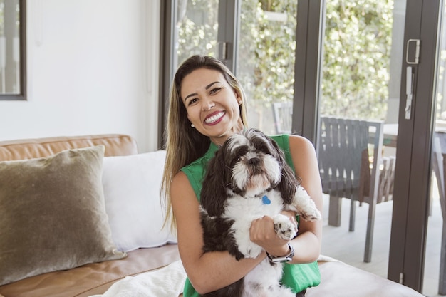 Foto mujer brasileña y su mascota perro shih tzu en casa, mejor amiga, amor familiar