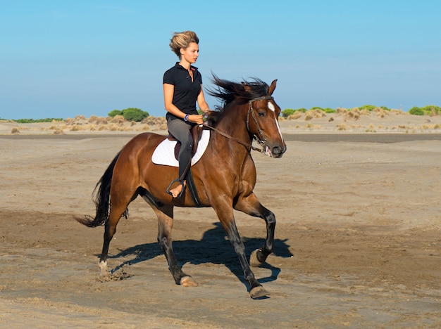 mujer caballo en la playa