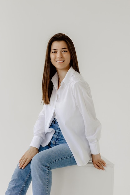 Foto una mujer con una camisa blanca está posando para una foto