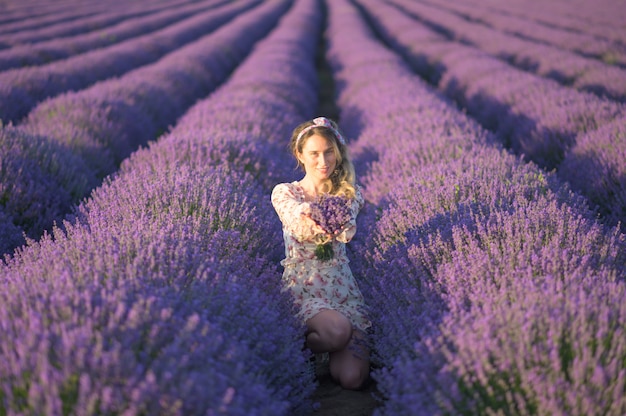 Mujer en campo de lavanda al atardecer con vestido de verano