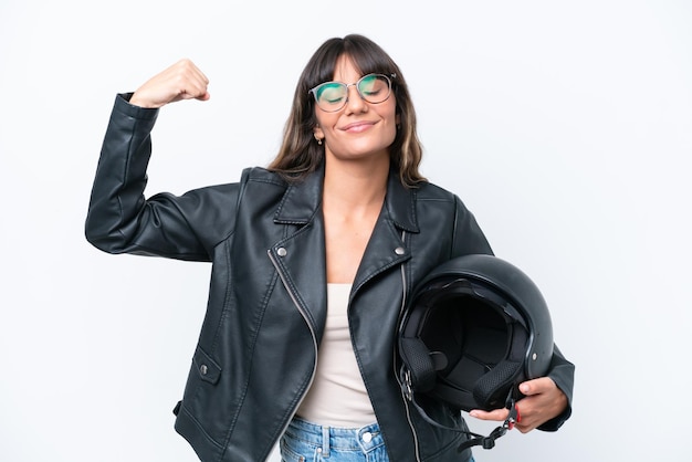 Foto mujer caucásica joven con un casco de motocicleta aislado sobre fondo blanco haciendo un gesto fuerte