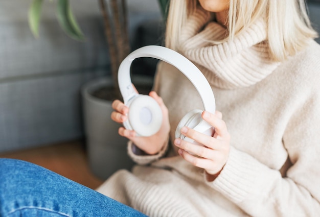 Mujer caucásica joven se relaja en casa con música