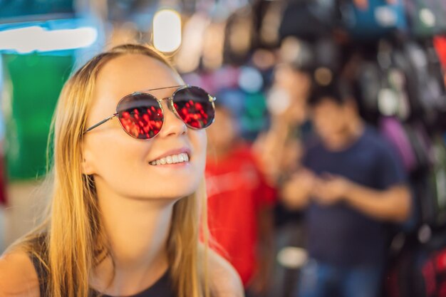 Mujer celebra el Año Nuevo chino mira las linternas rojas chinas Las linternas chinas se reflejan en gafas