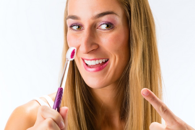 Foto mujer, cepillarse los dientes, con, cepillo de dientes