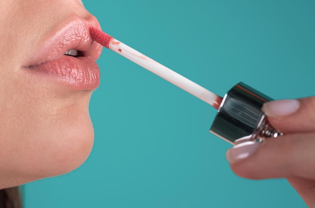 Mujer de cerca aplicando lápiz labial rojo en los labios Chica sexy aplicando lápliz labial maquillaje de lápiz labio rojo Poniendo lápiz lipstick en los labius