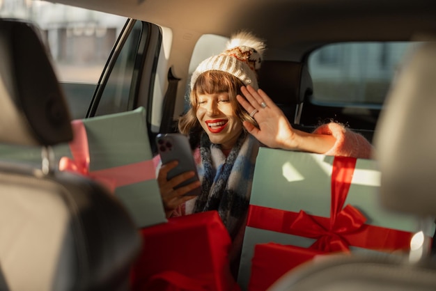 Mujer en coche con regalos de navidad