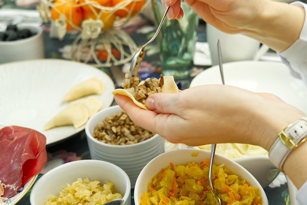 Mujer cocinando sabrosas bolas de masa hervida, de cerca. albóndigas caseras de bricolaje con diferentes rellenos. albóndigas de patata