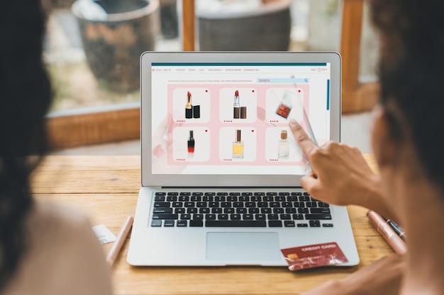 Foto mujer comprando en línea en el mercado de internet buscando artículos en venta para un estilo de vida moderno y usando tarjeta de crédito para pagos en línea desde una billetera protegida por un software crucial de seguridad cibernética