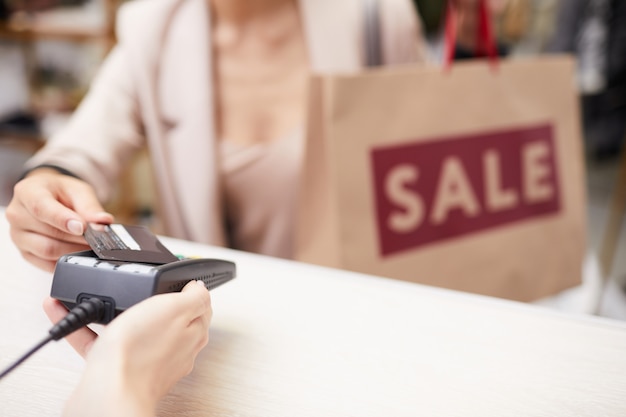 Foto mujer comprando ropa a la venta en boutique