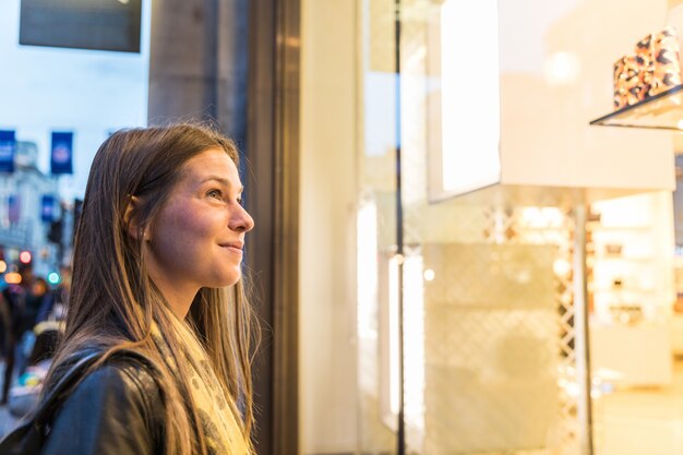 Mujer de compras en londres y mirando a un escaparate